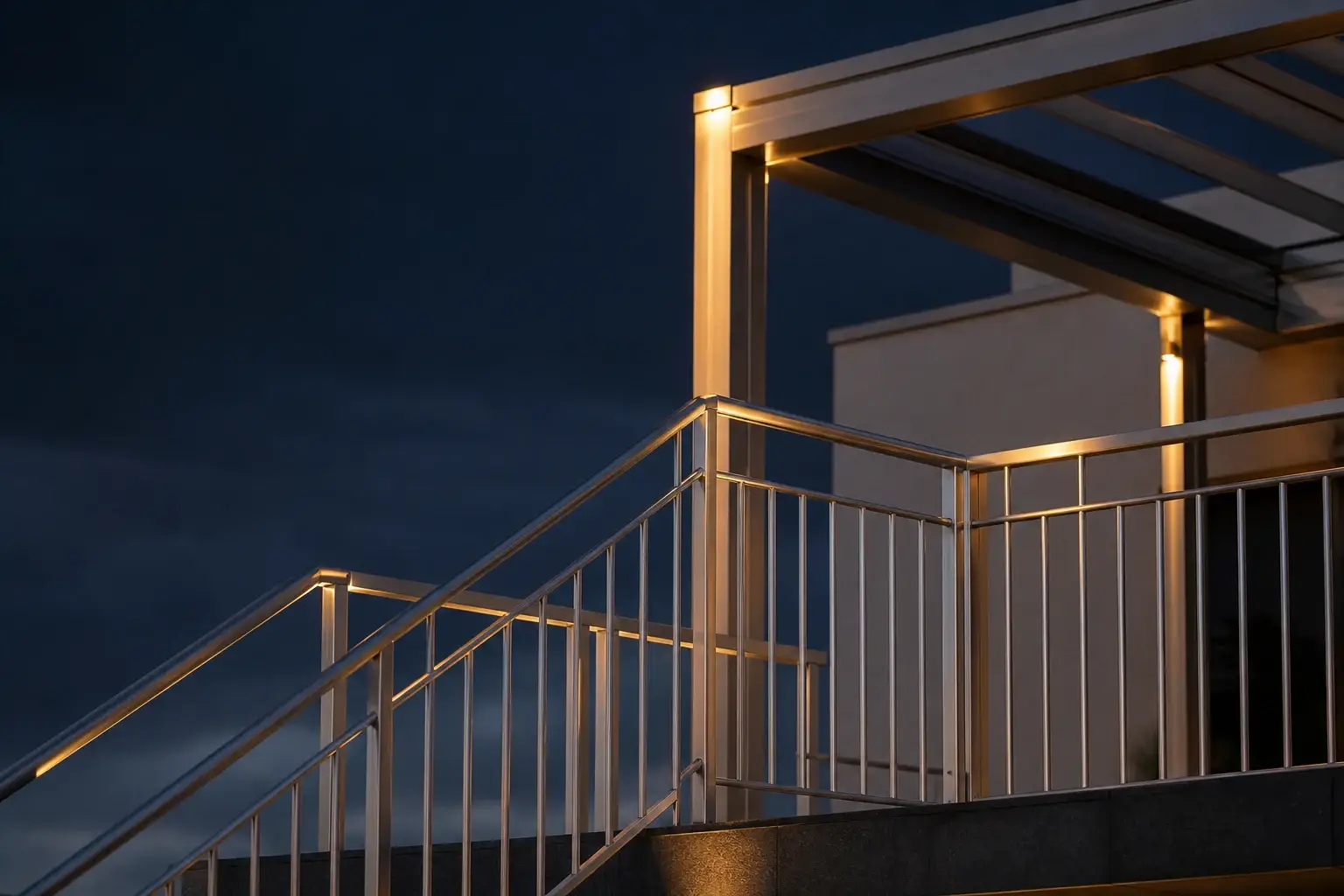 Outdoor aluminium railing and canopy framework catching warm light at dusk